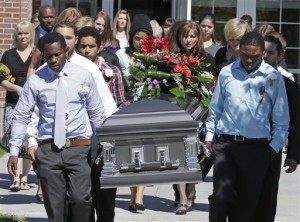 Pallbearers carry the casket of Darrien Hunt following funeral services Thursday, Sept. 18, 2014, in Saratoga Springs, Utah. Friends and family of the young black man fatally shot by Utah police remembered him Thursday as a shy, gentle and wise man who loved art and music and was trying to find his way through a transition into adulthood.  Hunt was killed on Sept. 10 in a strip mall in the upscale city south of Salt Lake City. The fatal shooting didn't get much attention until Hunt's mother came out days later and said she believed her son was shot because he was black. Authorities, however, say race played no role in the shooting. They say officers were reacting to Hunt lunging at them with a sword that had a 2.5-foot steel blade.(AP Photo/Rick Bowmer)