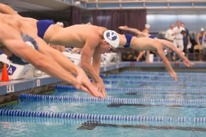 BYU swimmer Michael King (white cap) dives into the pool. (Universe photo)