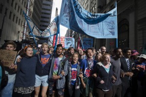 Protestors chant during a march demanding action on climate change and corporate greed, Monday, Sept. 22, 2014, a day after a huge climate march in New York. (AP Photo/John Minchillo)