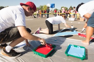 Members of United Ways give service to Cherry Hill Elemenary Elementary School by painting hopscotch's on the playground. Photo by Ari Davis.
