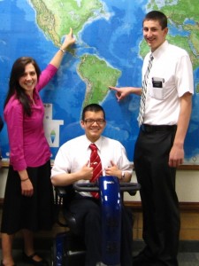 Zayne Callahan sits with Natalie Bishop, (left) and Alex Mitchell, (right,) in front of the MTC world map . Callahan served an MTC referral center mission. (Zayne Callahan)