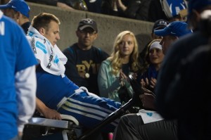 Fan watch as Taysom Hill is takin back to the locker room with a fractured leg in the game against Utah State. (Elliott Miller)