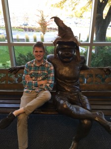 Ben Grange, events coordinator at The Wall, poses next to Cosmo the Cougar who wears the Hogwarts Sorting Hat.