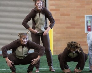 Women's soccer players do leg excersizes in their Halloween costumes.