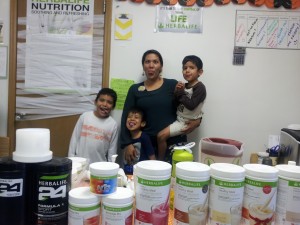 Ligia and her sons at Active Nutrition Zone making funny faces.
