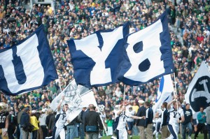 BYU cheerleaders lead the football team onto the field before a game. (Universe Photo)