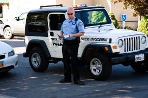 A Provo police officer issues parking tickets just south of the BYU campus. Parking may be one of the biggest worries for a BYU student with a car. (Drew Van Wagenen)