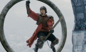 Ron Weasley celebrates after saving a goal during a Quidditch match against Slytherin.