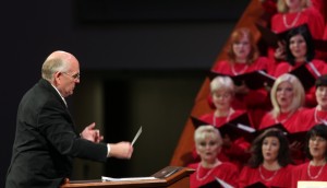 Mack Wilberg, music director of the Mormon Tabernacle Choir, leads choir members in song. (Mormon Newsroom)