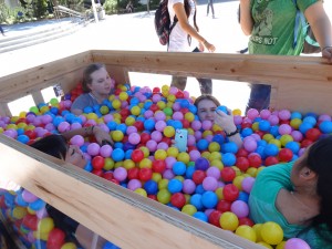 Students asking questions and getting to know each other in the ball pit at the Ball Pit Social. The Ball Put is brought to Brigham Square once a month to increase communication between students, faculty and friends. (Cara Wade)