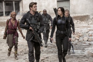 Jennifer Lawrence portrays Katniss Everdeen, right, and Liam Hemsworth portrays Gale Hawthorne in a scene from "The Hunger Games: Mockingjay Part 1." (AP Photo/Lionsgate, Murray Close)