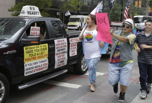FILE-This Wednesday, Aug. 6, 2014 file photo shows gay marriage supporters following an opponent of gay marriage driving his truck around Fountain Square where several hundred gay marriage supporters held a rally in Cincinnati. After a series of developments on gay marriage this week, theres growing anticipation for a ruling by the federal appeals court in Cincinnati. A 6th U.S. Circuit Court of Appeals panel heard arguments two months ago on challenges to gay marriage bans in four states. Its eventual ruling could help determine when or even whether the U.S. Supreme Court takes up the issue.(AP Photo/Al Behrman, File)