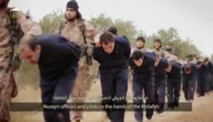 This still image taken from an undated video published on the Internet by the Islamic State group militants and made available, Sunday, Nov. 16, 2014, purports to show extremists marching Syrian soldiers before beheading them. The high-definition video later shows the beheadings of about a dozen men identified as Syrian military officers and pilots, all dressed in blue jumpsuits. The Associated Press could not independently verify the footage, though it appeared on websites used in the past by the Islamic State group, which now controls a third of Syria and Iraq. (AP Photo)