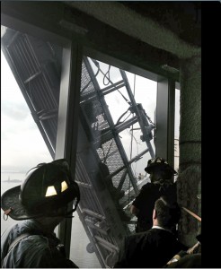 This photo, from the Fire Dept. of New York Twitter page, shows a window washer's gondola as it hangs from 1 World Trade Center, in New York, Wednesday, Nov. 12, 2014.  Two workers are stuck on scaffolding 69 stories above street level.  A police official, John Miller, says the partially collapsed scaffolding is hanging at "a 75-degree angle." The Fire Department said the workers are tethered and communicating with rescuers. (AP Photo/Fire Dept. of New York, Twitter)