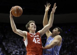 Utah forward Jakob Poeltl (42) shoots as BYU center Corbin Kaufusi (44) defends in the first half of an NCAA college basketball game Wednesday, Dec. 10, 2014, in Provo, Utah. (AP Photo/Rick Bowmer)