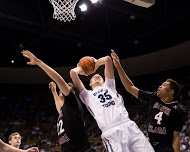 Isaac Neilson fights for a rebound against Santa Clara. Rebounding was a key to the Cougars' victory against the Broncos.