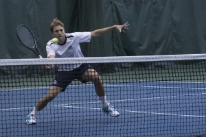 Jeremy Bourgeois volleys the ball during the Cougar's opening match on Jan. 10. (Ari Davis)
