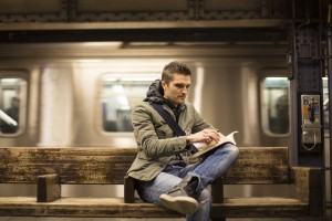 Author Slade Combs reads through The Choice in a subway station. Combs wrote the book to open dialogue about the issue of child sexual abuse. (Corinne Monson)
