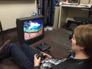Hunter Phillips tests games and TVs for the History of Video Games Exhibit. BYU will hold its first Video Games Symposium Feb. 12- Feb. 14. (Video Games Symposium FB Page)