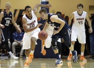 Pepperdine's Lamond Murray Jr, center left, and BYU's Kyle Collinsworth chase a loose ball during the second half of an NCAA college basketball game Thursday, Feb. 5, 2015, in Malibu, Calif. Pepperdine won 80-74. (AP Photo/Jae C. Hong)