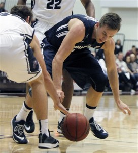 BYU guard Kyle Collinsworth, right, battles Loyola Marymount guard David Humphries for the ball during the first half of an NCAA college basketball game in Los Angeles, Saturday, Feb. 7, 2015. (AP Photo/Alex Gallardo)