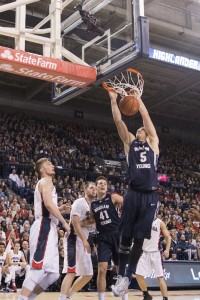 Kyle Collinsworth dunks against Bulldog defenders, adding to his 20 point game. (Bryan Pearson)