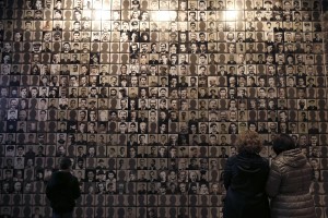Visitors look at portraits of victims at the Holocaust Museum in the town of Kalavryta, western Greece. (Associated Press)