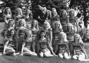 1990's Cougarettes pose with the BYU Cougar statue on campus. The dancers are sporting the famous "Coug-Do" which was popular at the time. (Photo courtesy of Jodi Maxfield)