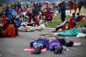 In this photo provided by China's Xinhua News Agency, tourists sleep at an open space after an earthquake in Kathmandu, Nepal, Sunday, April 26, 2015. Planeloads of aid material, doctors and relief workers from neighboring countries began arriving Sunday in Nepal, a poor Himalayan nation reeling from a powerful earthquake that destroyed infrastructure, homes and historical buildings. (Associated Press)