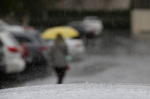 Rain drops fall on a car parked outside a building, Friday, May 15, 2015, in Buena Park, Calif. A second round of rain from a rare spring storm swept into drought-stricken Southern California on Friday, along with heavy winds, snow in the mountains and the possibility of hail and lightning. (AP Photo/Jae C. Hong)