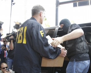 Federal agents load a van with boxes of evidence taken from the headquarters of the Confederation of North, Central America and Caribbean Association Football (CONCACAF,) Wednesday, May 27, 2015, in Miami Beach, Fla. Swiss prosecutors opened criminal proceedings into FIFA's awarding of the 2018 and 2022 World Cups, only hours after seven soccer officials were arrested Wednesday pending extradition to the U.S. in a separate probe of "rampant, systemic, and deep-rooted" corruption. (AP Photo/Wilfredo Lee)