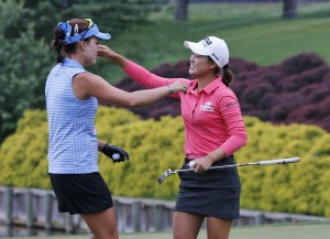 Minjee Lee, of Australia, right, hugs fellow golfer, Lexi Thompson, left, on the 18th hole of the rain delayed Kingsmill Championship LPGA golf tournament at the Kingsmill Golf Club in Williamsburg, Va., Monday, May 18, 2015. Lee won the tournament. (AP Photo/Steve Helber)