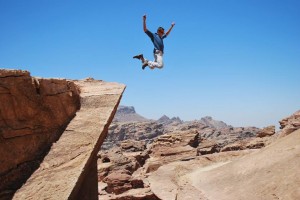 A student jumps off a cliff. 