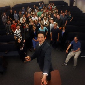 Ryan Wallace, BYU political science major and volunteer institute teacher uses a selfie stick to capture a picture of everyone in his class. (Ryan Wallace)