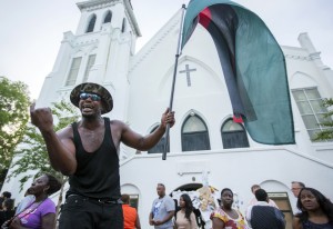 A man yells in front of the Emanuel AME Church during a march down Calhoun Street on Tuesday, June 23, 2015. The march comes six days after a gunman shot nine people during bible study inside the church. (AP Photo/Mic Smith)