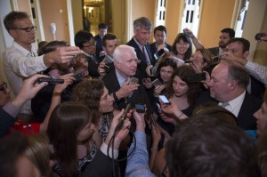 Sen. John McCain, R-Az., is surrounded by reporters as he walks to the Senate Chamber to begin a special session to extend surveillance programs, in Washington, Sunday, May 31, 2015. Senate Republicans say they've been unable to make a deal to extend contested anti-terror provisions. As a result, the post-Sept. 11 programs will expire at midnight. (AP Photo/Cliff Owen)