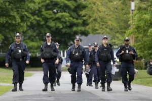 Law enforcement officers walk the streets in Dannemora, N.Y., as they searched houses near the maximum-security prison in northern New York where two killers escaped using power tools,Wednesday, June 10, 2015. State Police said the fifth day of searching will entail going from house to house in Dannemora, where David Sweat and Richard Matt cut their way out of the Clinton Correctional Facility. (AP Photo/Seth Wenig)