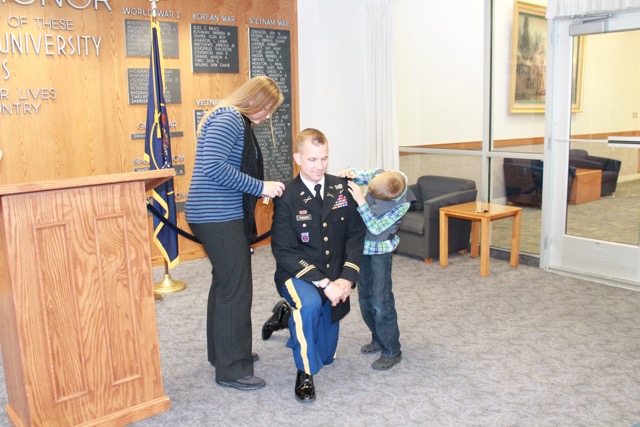 Nikki and Enoch put the new shoulder boards on Timmons for his new rank. Timmons wife Nikki and son Enoch were there to watch the promoted. (Shombree Wojcik)