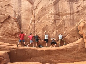 A group of BYU students pose on a ledge in Moab during a weekend road trip. Moab is known for its beautiful red rock and great hikes. (Sarah Wright)