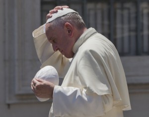 Pope Francis exchanges his skull cap with one donated to him as he leaves at the end of his weekly general audience in St. Peter's Square at the Vatican, Wednesday, June 10, 2015. (AP Photo/Alessandra Tarantino)