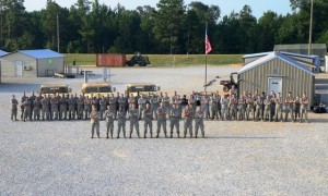 Staff lines up for a photo at field training from 2014. The field training is designed to simulate life on active duty in the military. (MSgt Maria D. Perrin)