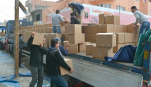 Volunteers from the IRC unload boxes from a truck. The IRC is one of the organizations designed to help refugees.