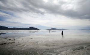This Saturday, July 18, 2015, photo, shows visitors walking on the Bonneville Salt Flats, in Utah. The Speed Week races that draw hundreds of racing teams from around the world to Utah's famous salt flats have been canceled for the second consecutive year because of wet conditions. The event organizers announced the cancellation Monday, July 20, of an event that was scheduled to start Aug. 8. (AP Photo/Rick Bowmer)