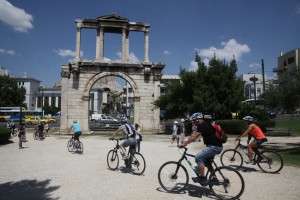 Tourists bike through Greece. Greece has become a lot cheaper as a destination.