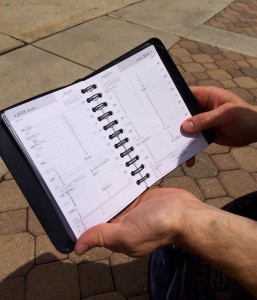 Taylor Moss opens his planner to show a typical day. This planner has helped him keep track of his busy schedule. (Taylor Ricks)