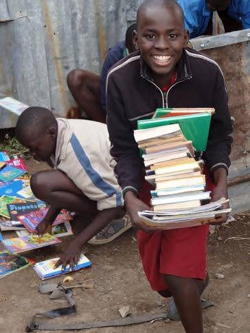 An orphan receiving school supplies at an orphanage in Kenya, Africa, where Katelyn Johnson, a Utah Valley Universty student, voulenteered. (Katelyn Johnson)