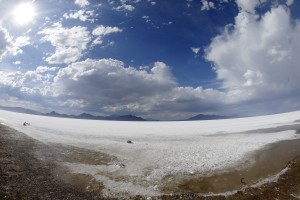 This Friday, July 17, 2015, photo taken with a wide angle lens, shows the Bonneville Salt Flats, in Utah. The Speed Week races that draw hundreds of racing teams from around the world to Utah's famous salt flats have been canceled for the second consecutive year because of wet conditions. The event organizers announced the cancellation Monday, July 20, of an event that was scheduled to start Aug. 8. (AP Photo/Rick Bowmer)