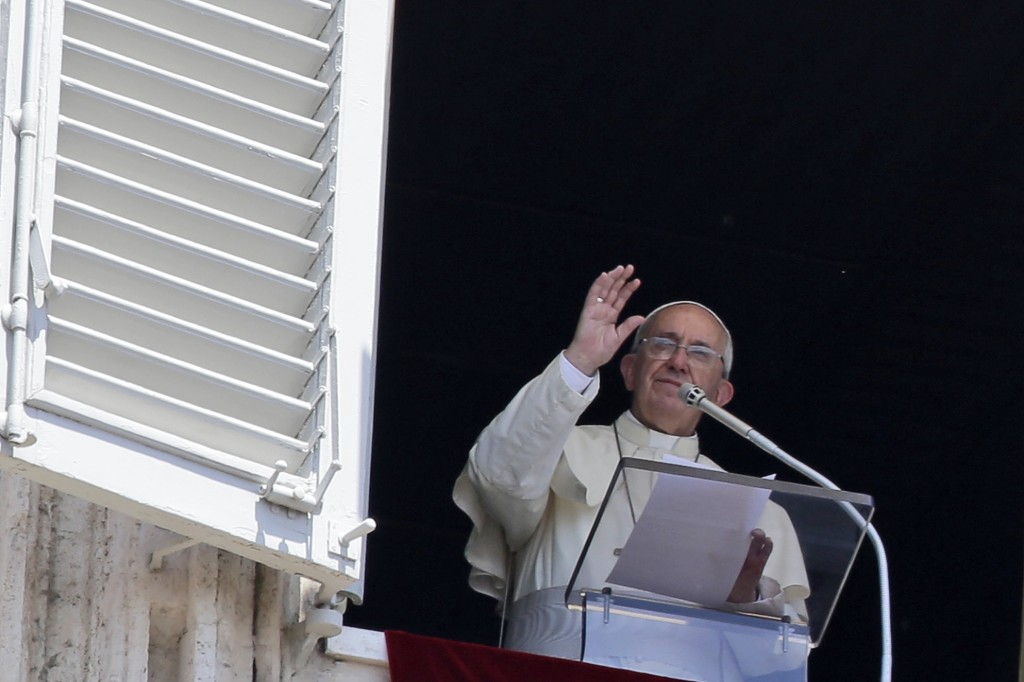 Pope Francis delivers a blessing during the Angelus noon prayer he delivered from his studio's window, in St. Peter's Square, at the Vatican, Sunday, July 19, 2015. Speaking from his studio window, Francis told the crowd Sunday in St. Peter's Square: "I see you are courageous with this heat in the square. A tip of the hat to you!" Many faithful used sun umbrellas. Temperatures in Rome this week could hit 38-39C (100-102F). Sizzling heat and oppressive humidity have gripped Italy this month, with some nights in Rome seeing "low" temperatures hovering near 30C (86F). (AP Photo/Gregorio Borgia)