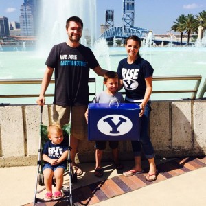 Dana Eyerly & her family with their BYU50 box. The Eyerlys found the box right after it was dropped because they waited in the Florida heat for five hours. (BYU Athletics)