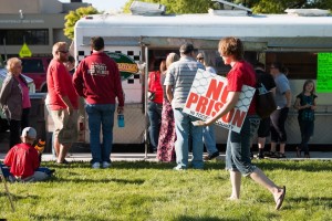 Protesters take a break for food at a rally preceding the Prison Relocation Commission information session in Grantsville on Thursday, May 28, 2015.
